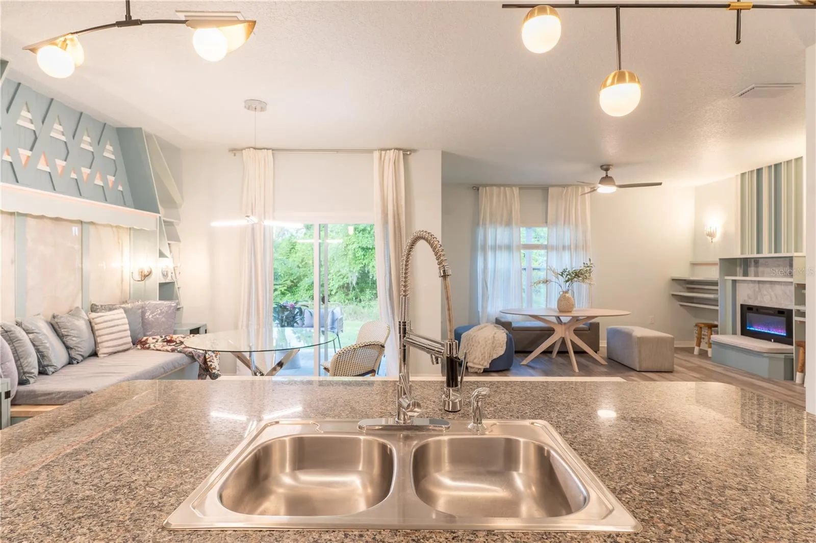 View of breakfast nook and living room from kitchen