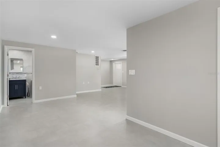 Standing in kitchen looking toward dining and living rooms with bath