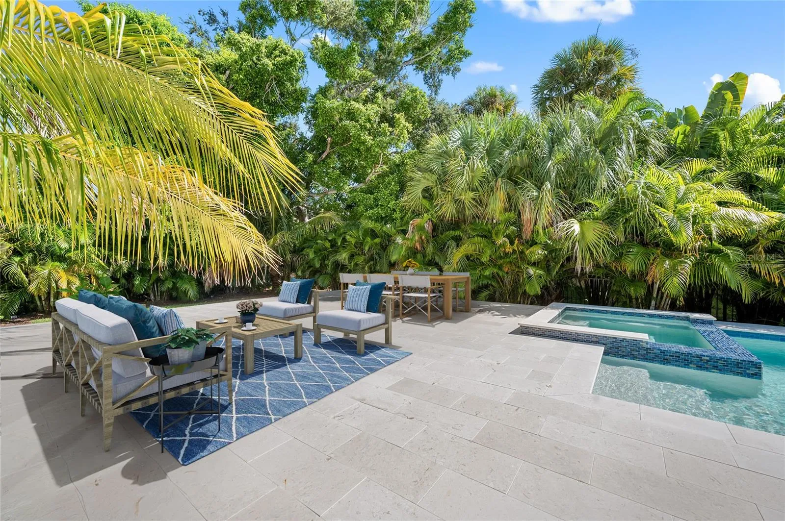 Virtually staged additional gathering space on pool deck in fenced and private back yard.