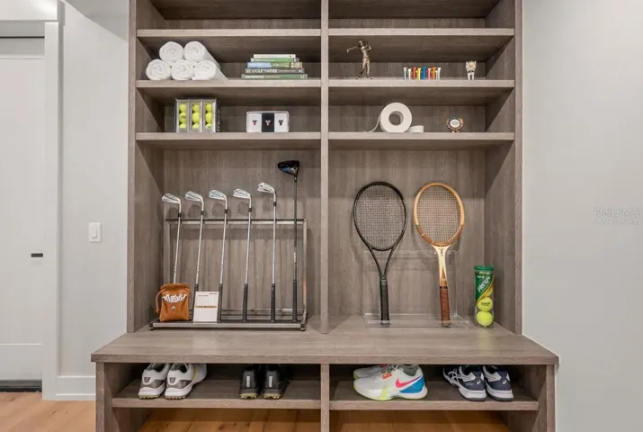 Virtually staged mudroom entry featuring custom built-ins with abundant storage for an active lifestyle.