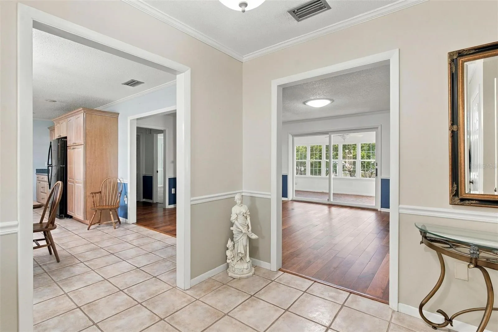 Inviting entry to living room, dining and kitchen space.