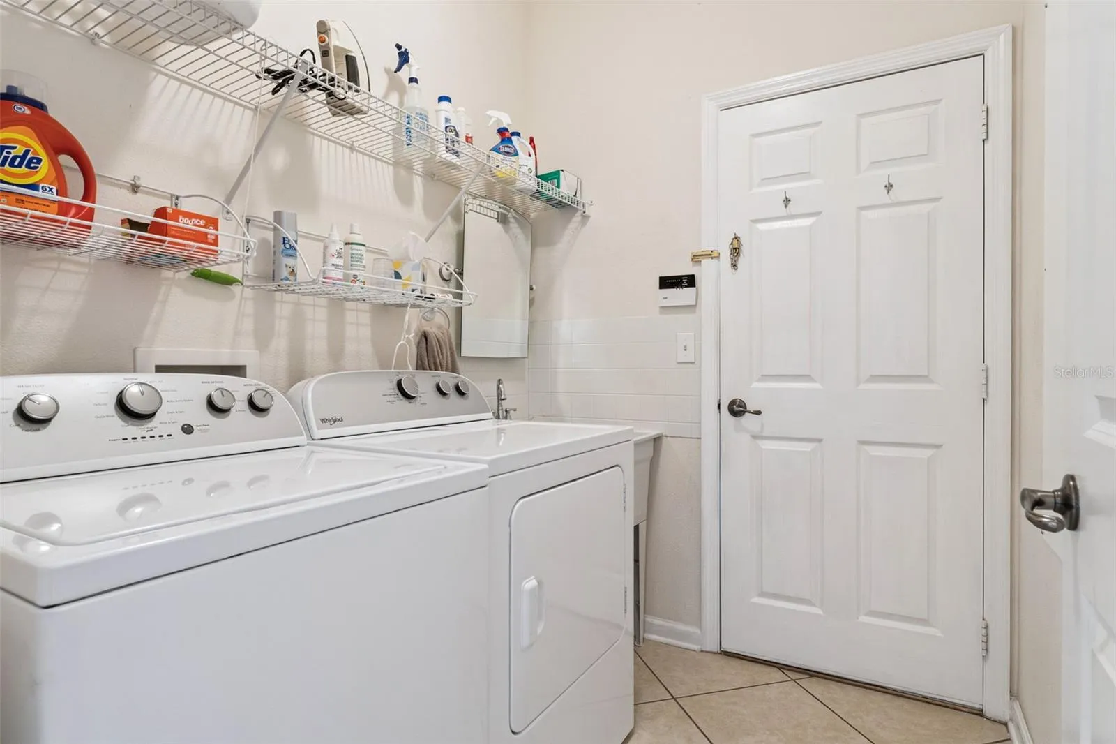 5'6" x 7' Utility Room w/ a laundry tub, washer, electric dryer &amp; a natural gas connection for a future use
