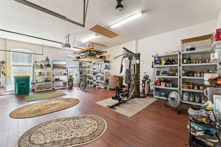 25'6" x 19'9" Garage w/ engineered wood flooring, insulated garage door, pull down attic stairs, ceiling fan &amp; additional electrical outlets