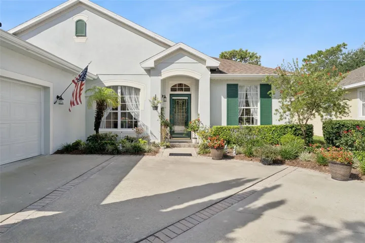 Exterior front of the home w/ a leaded glass front door &amp; storm door