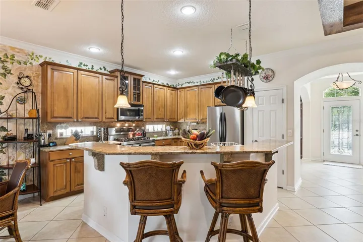 View of the Kitchen &amp; breakfast bar w/ pendant lights above