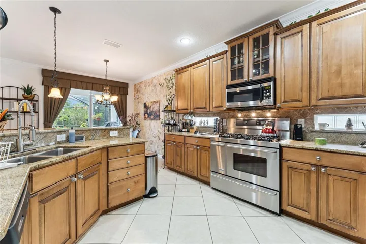 Kitchen w/ stainless steel appliances, tile backsplash &amp; 42" Maple cabinets