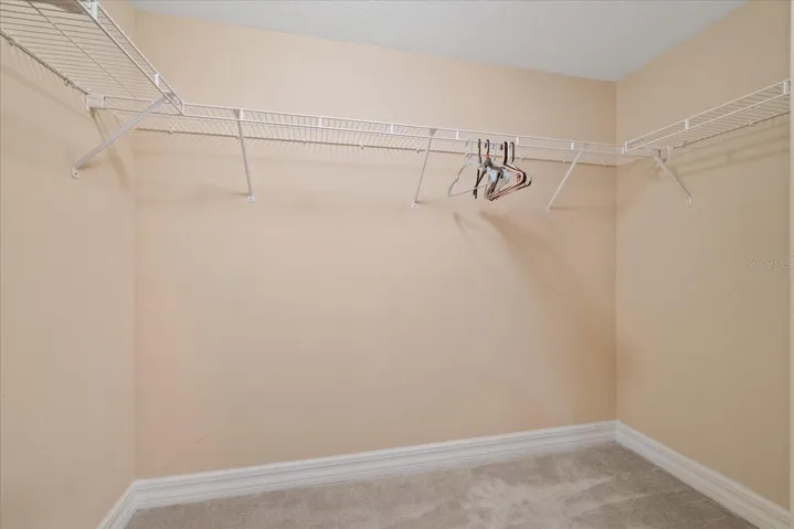 walk in primary bedroom closet