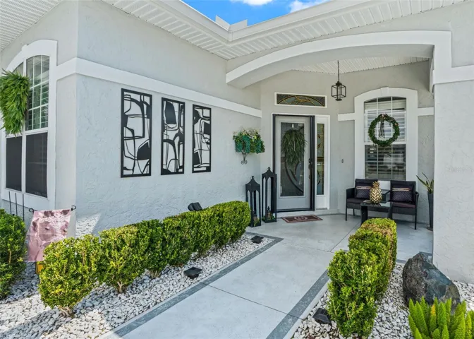 Covered front entrance w/Elegant front door w/Sidelight accent