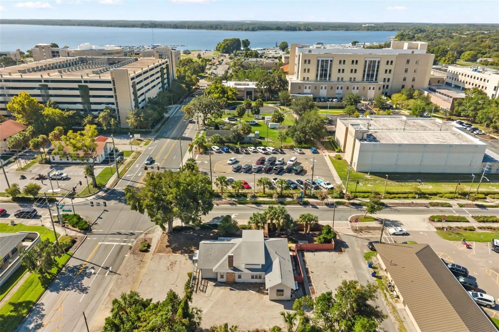 Downtown Tavares, office building front center, courthouse, parking garage and Lake Dora in view