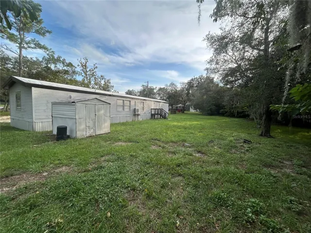 Back view with storage shed