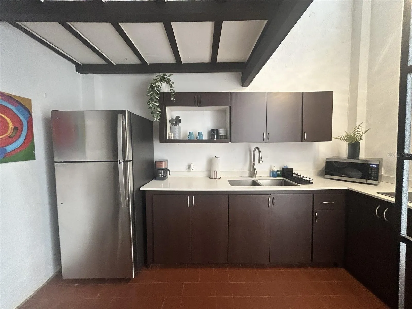 Remodeled kitchen with refrigerator, stove and microwave Remodeled kitchen with refrigerator, stove and microwave