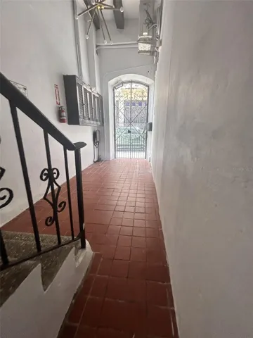 Ground-floor hall seen from the 1C door, looking back to the street gate