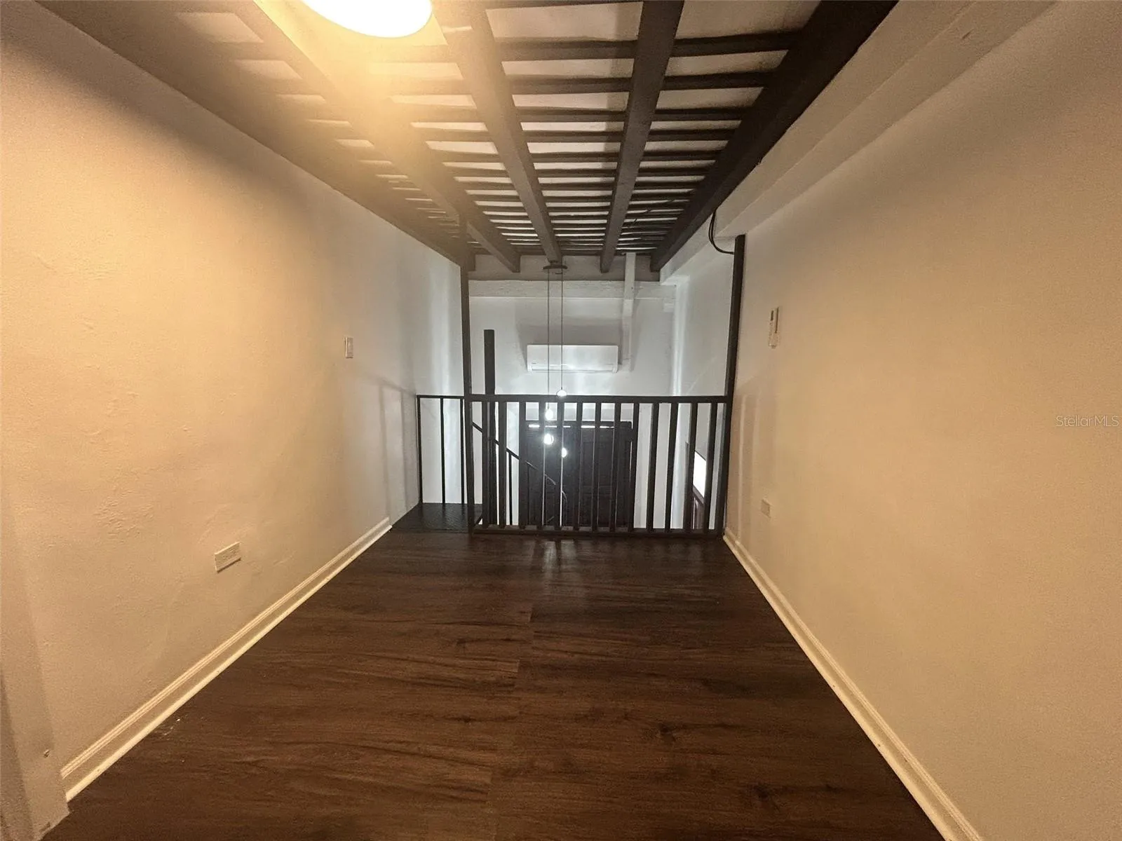 Master bedroom, upper level, above the kitchen and living room, wood floor
