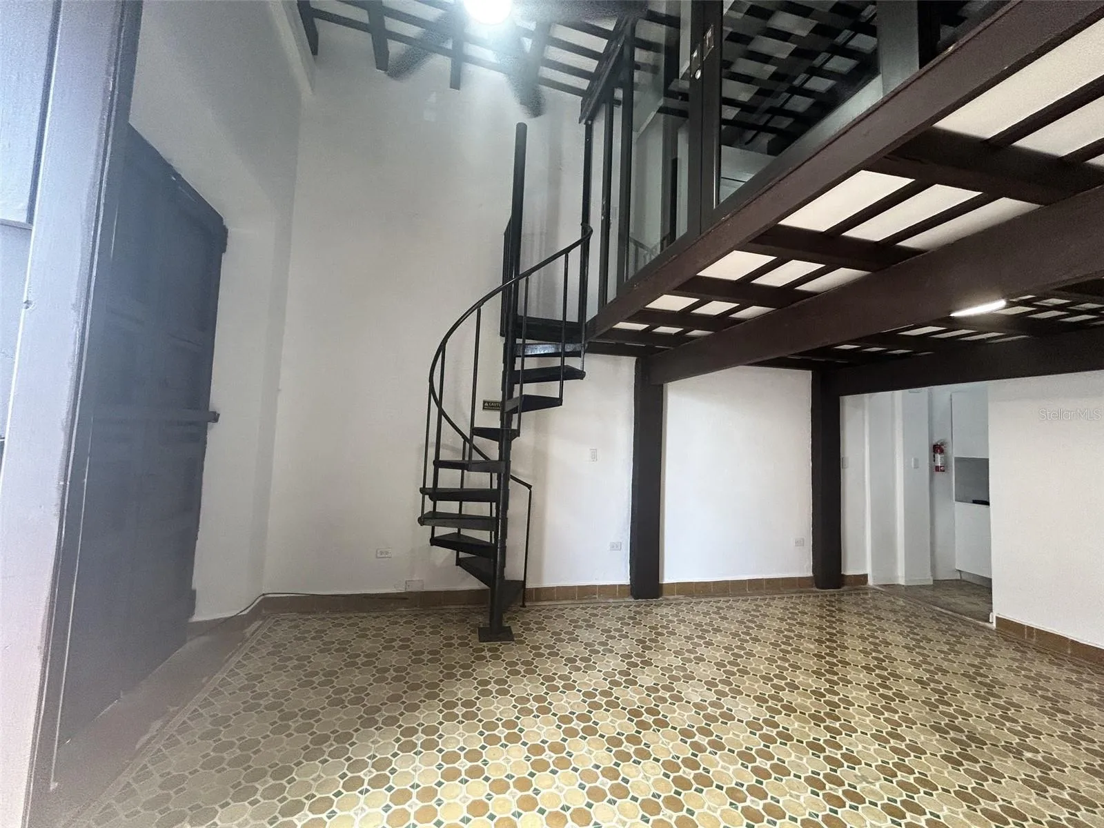 Living room and spiral staircase up to the master bedroom