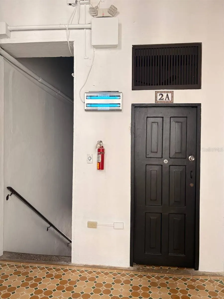 Unit 2A door, right beside the top of the staircase