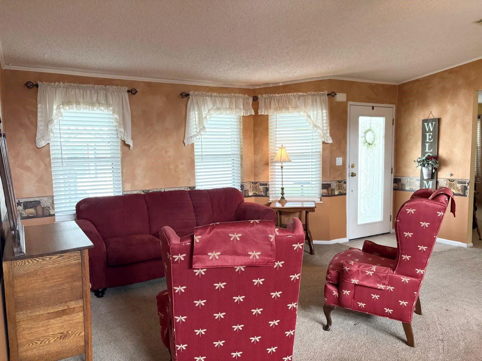 Living room open to dining room and side entrance