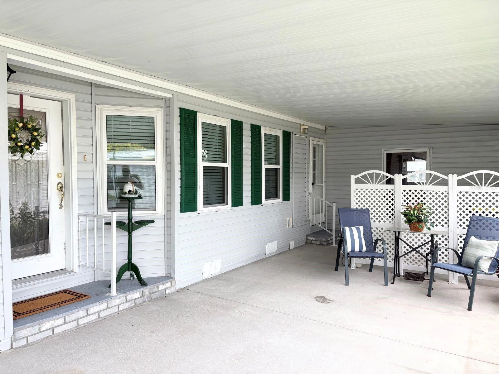 Covered carport and patio with storage shed