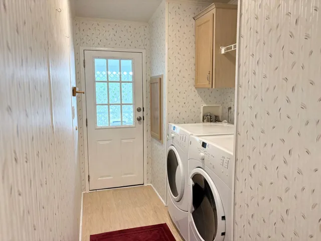 Laundry room with access to carport and storage shed