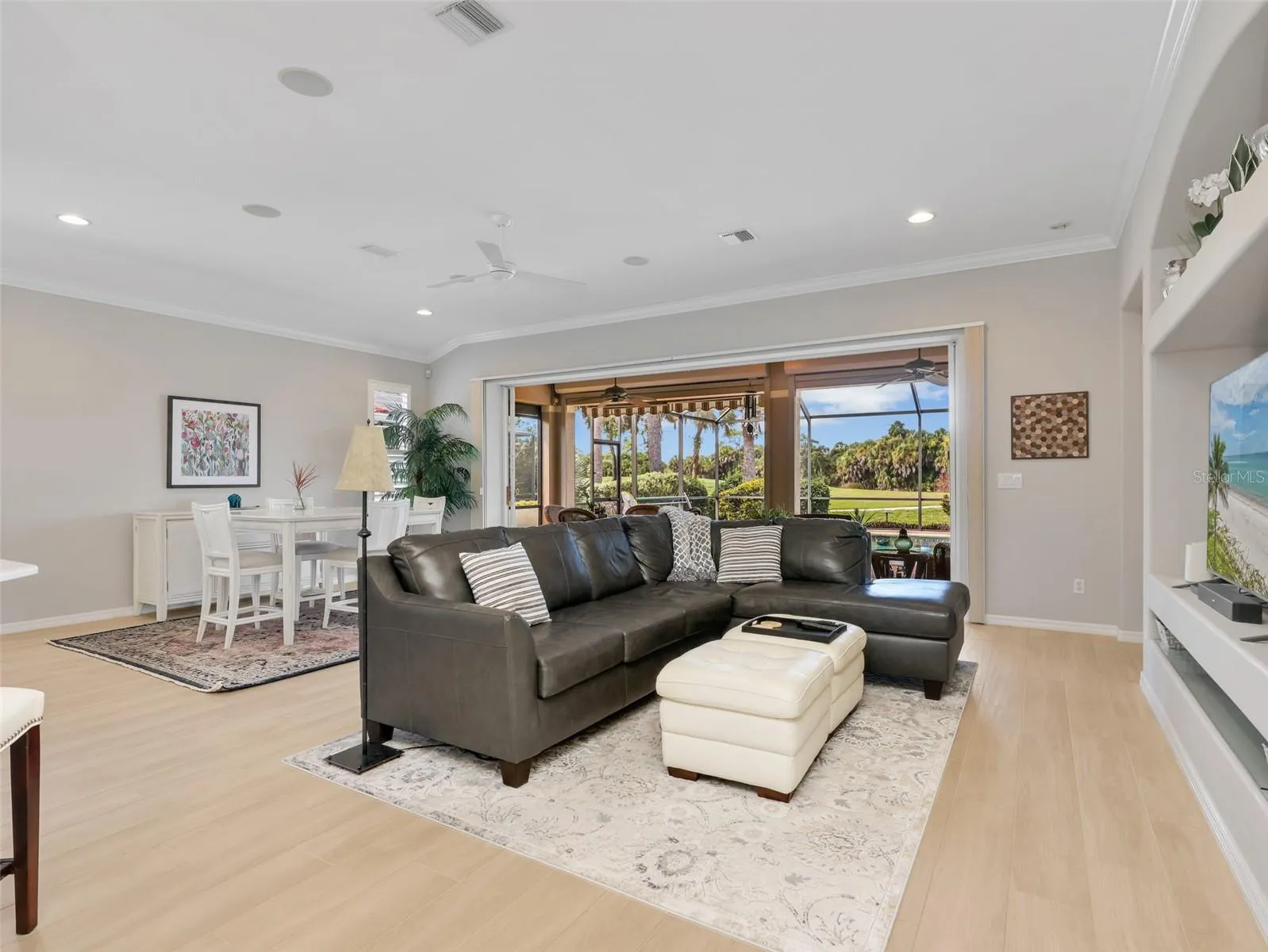 Spacious living area with high ceilings and views toward the pool.