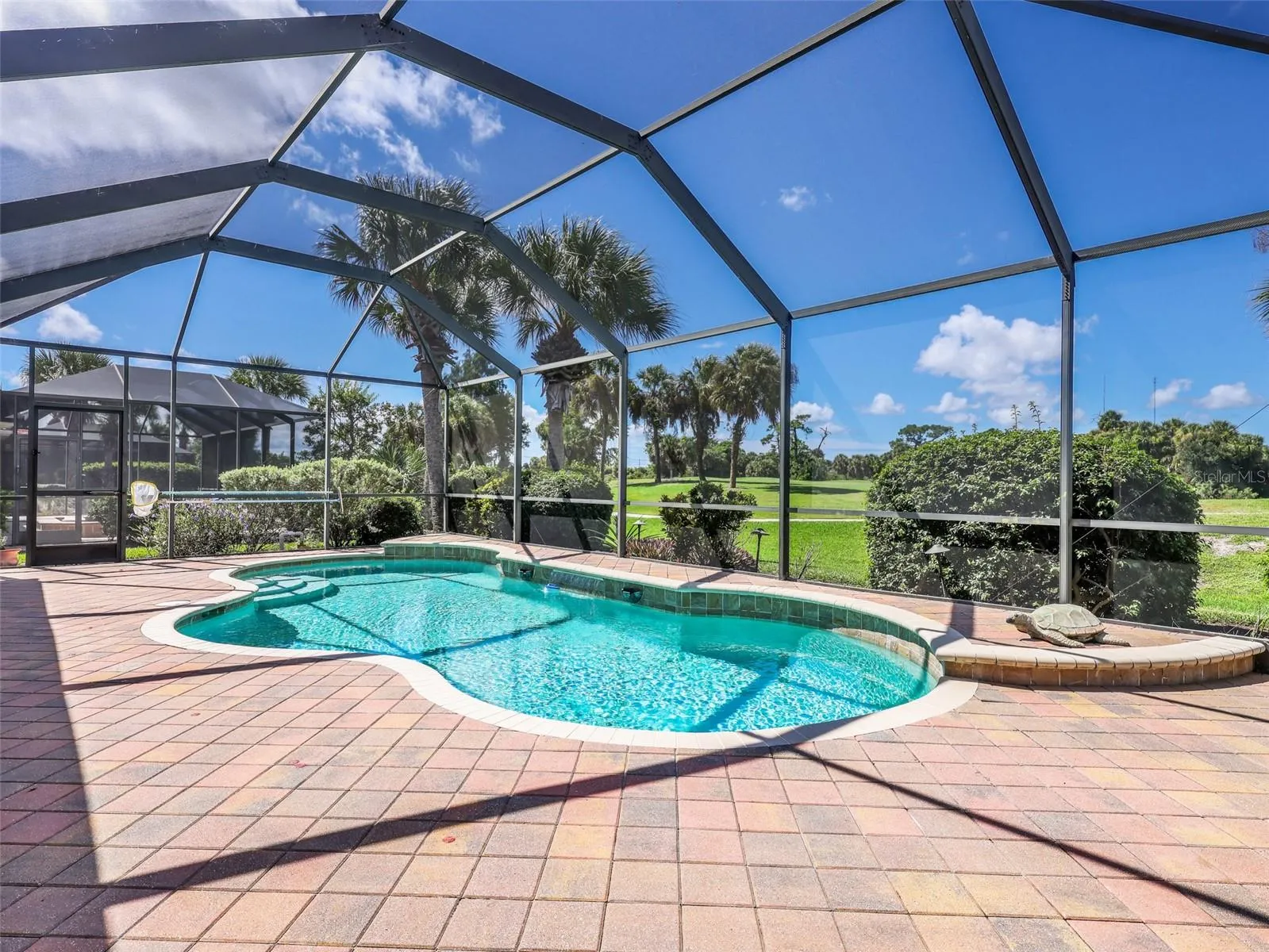 Peaceful pool setting with golf course views.
