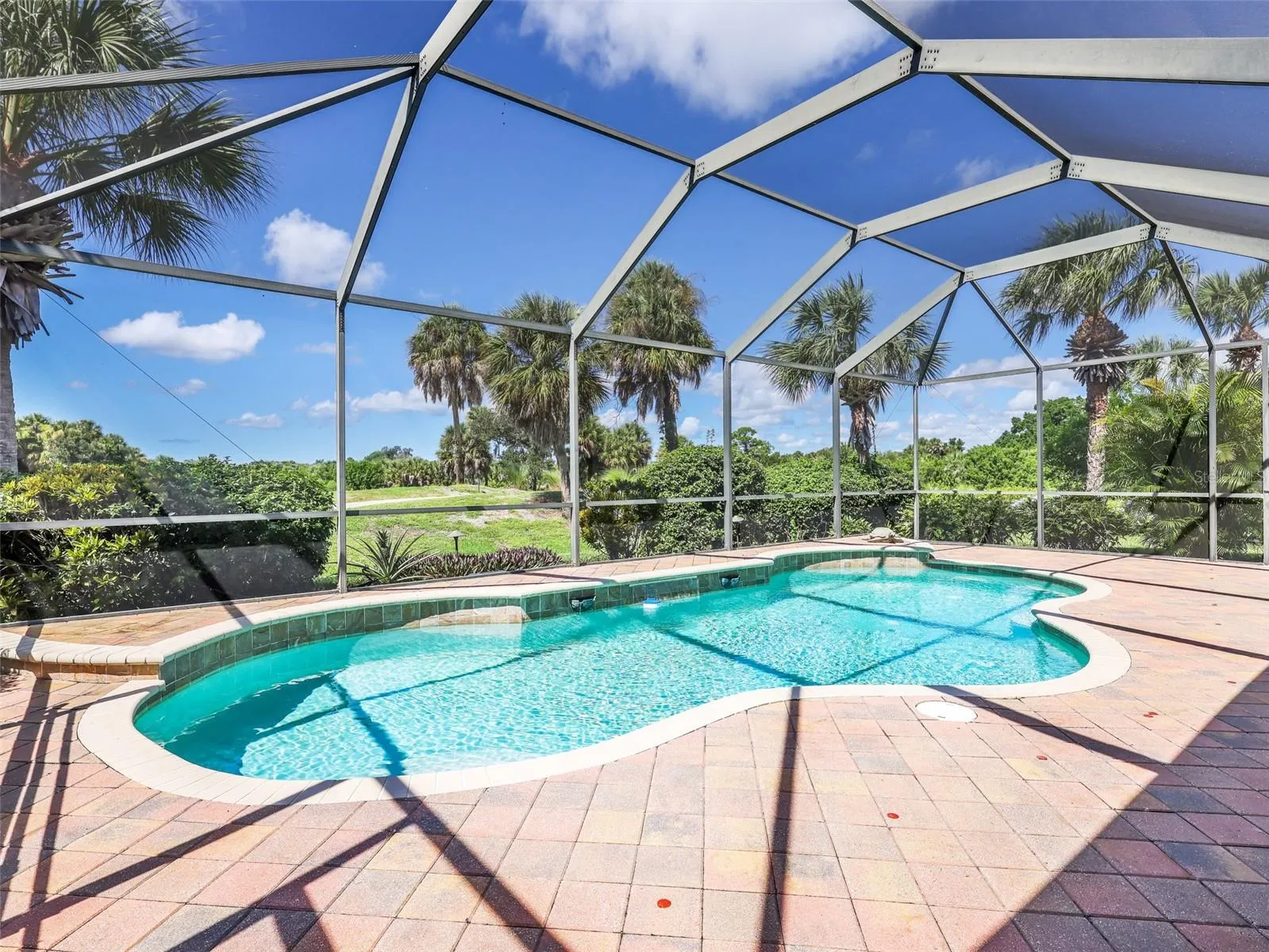 Private screened pool overlooking the golf course and landscaping