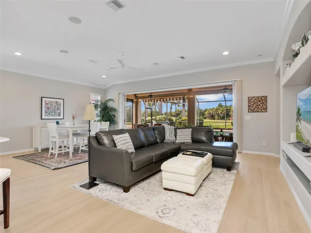 Spacious living area with high ceilings and views toward the pool.