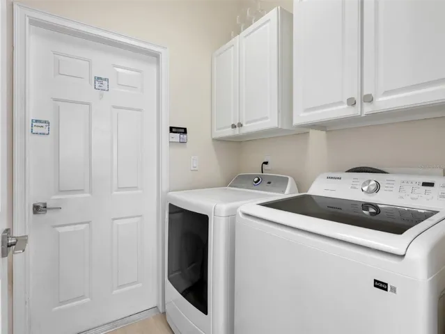 Interior laundry room with additional cabinetry and storage.