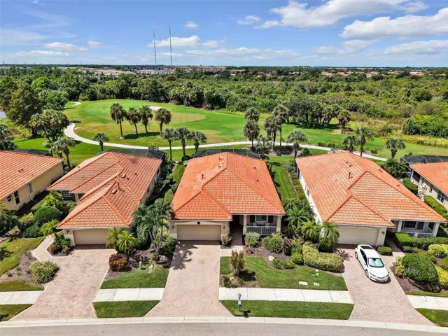 Aerial view of 194 Treviso Court with the golf course just beyond the backyard