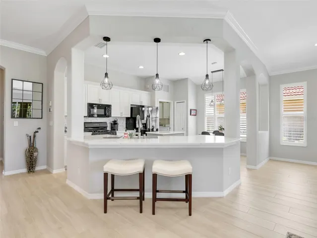 Updated kitchen with white cabinetry, new countertops, and a center island.