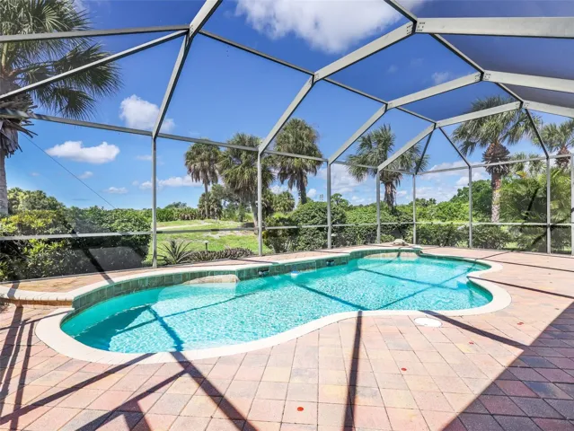 Private screened pool overlooking the golf course and landscaping