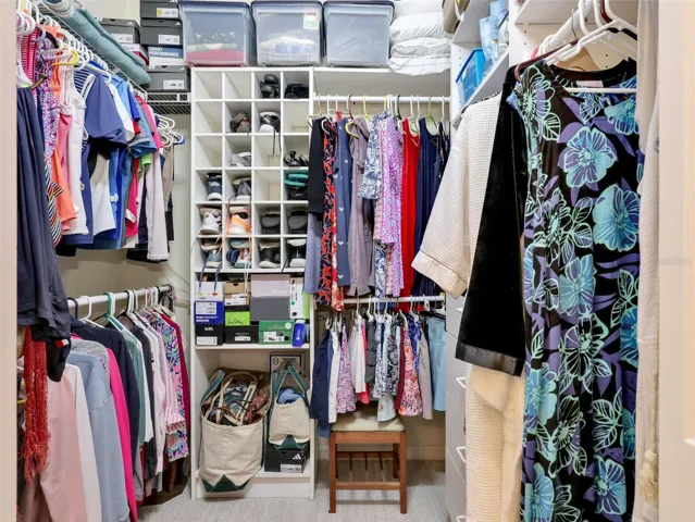 Large walk-in closet with plenty of storage.