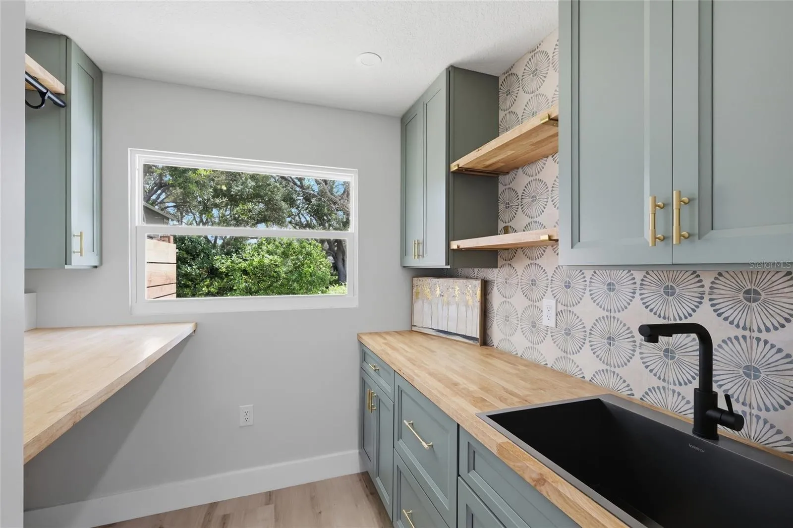 Gorgeous utility room with cabinetry, storage and sink
