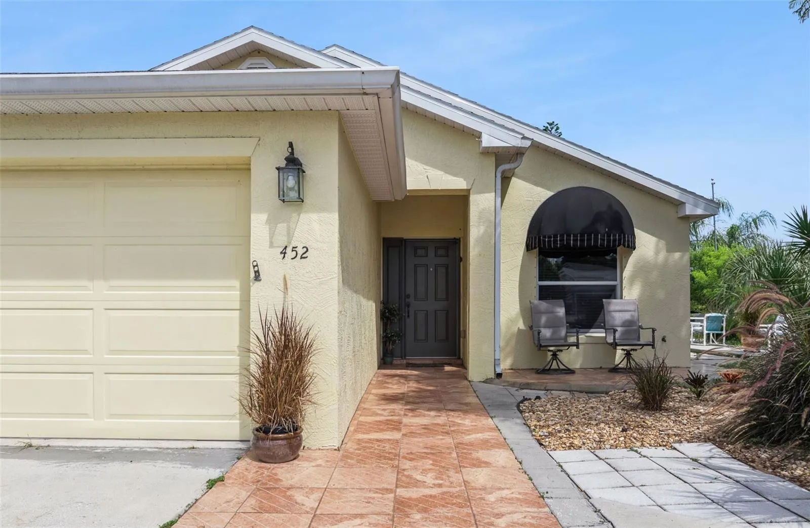 A charming front patio and covered entry welcome you upon arrival