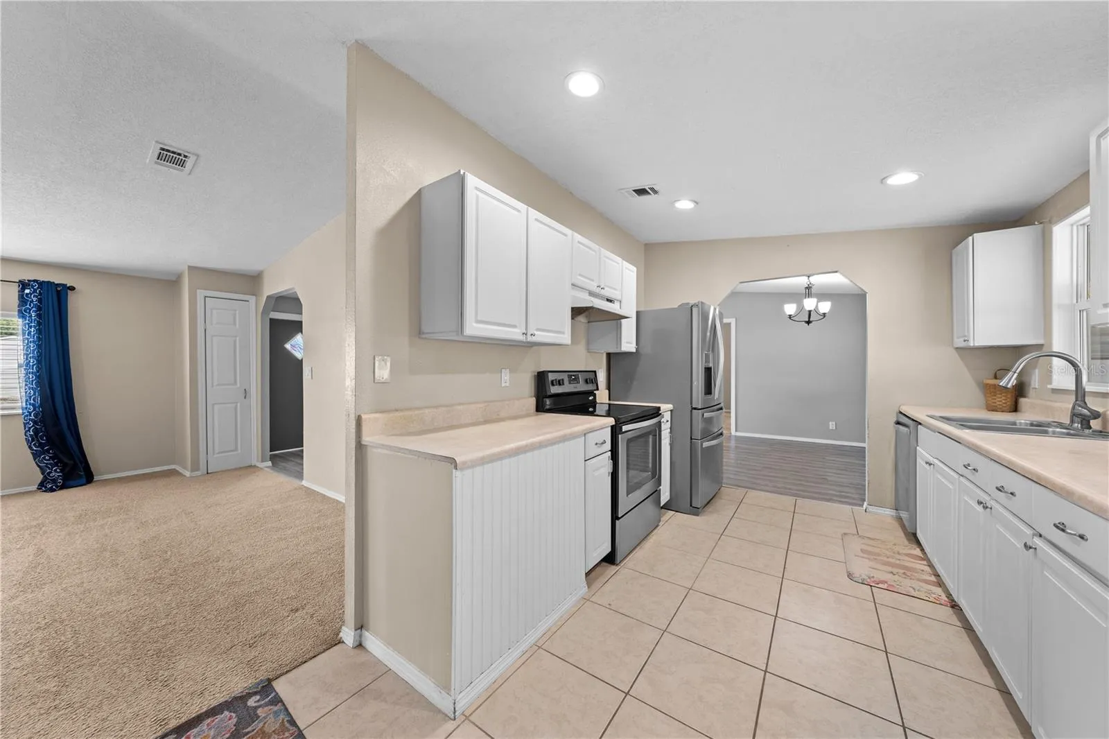 Kitchen with family room to the left and dining room straight ahead