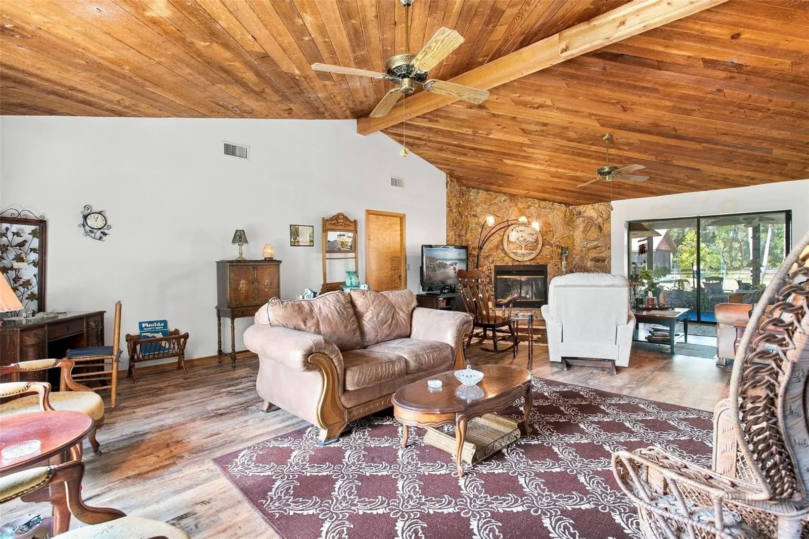 Living room with vaulted cedar ceilings.
