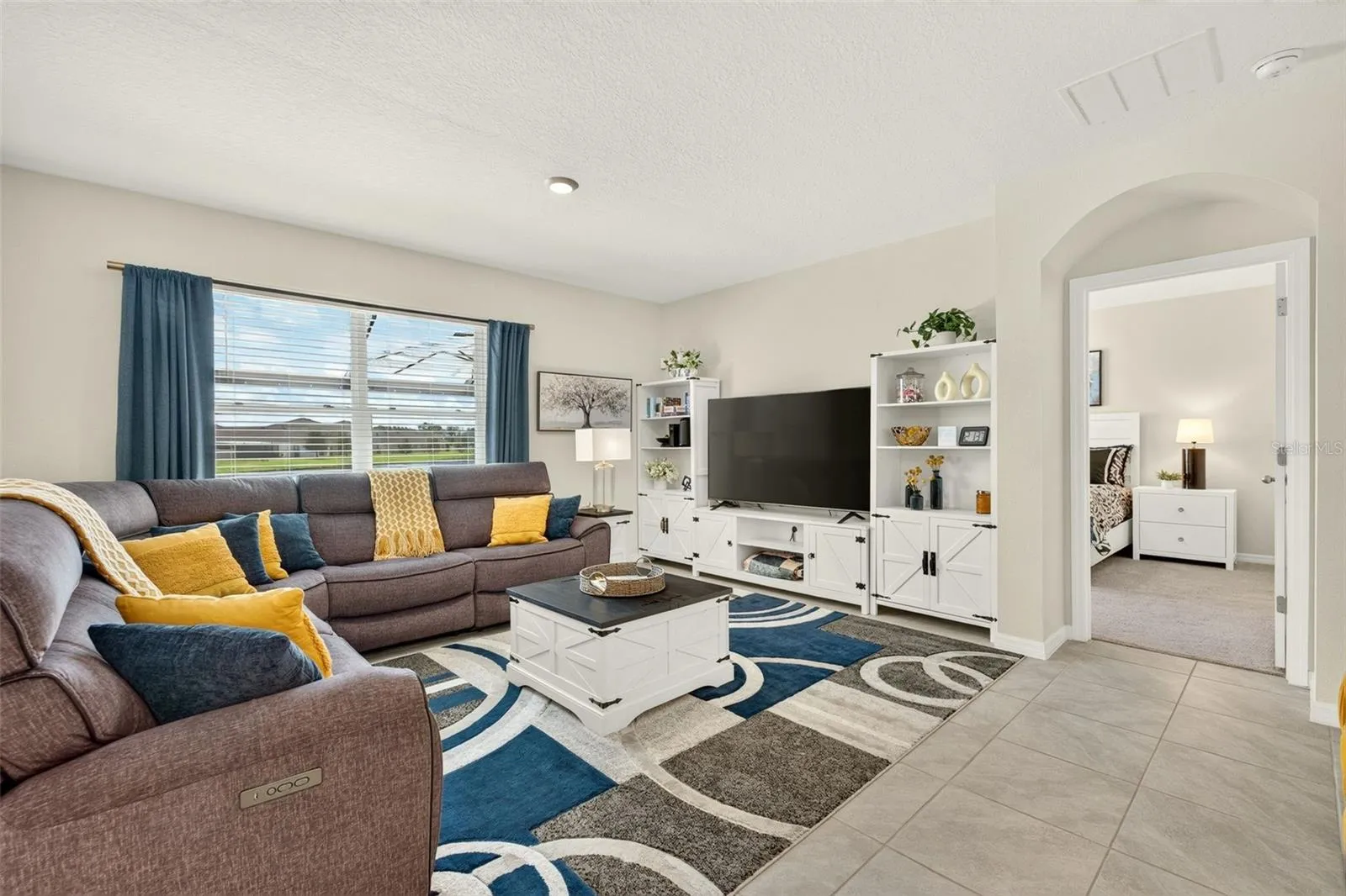 Bright and spacious great room, open to the kitchen and view of the pool area
