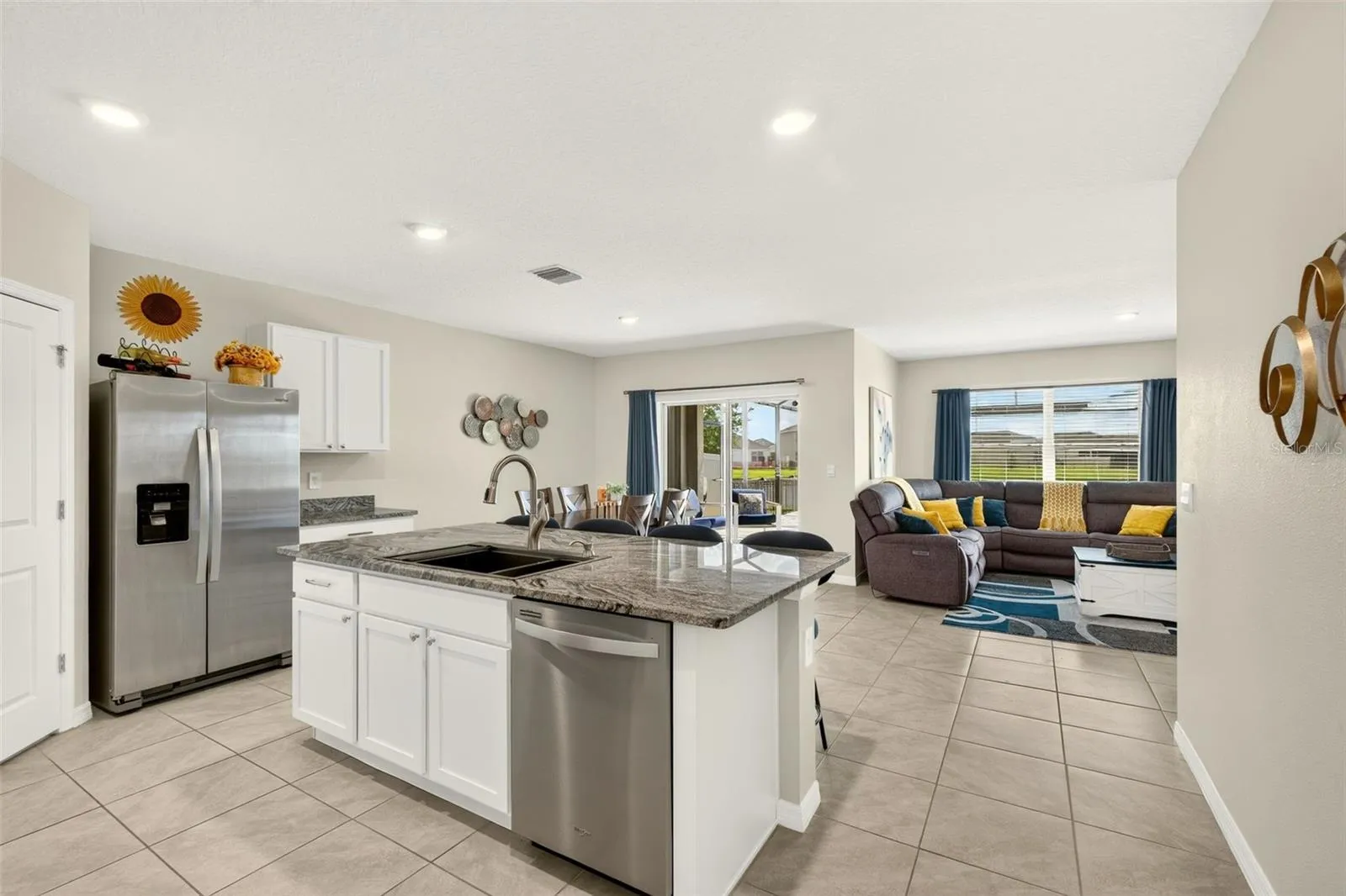 The heart of the home; bright, open kitchen with large center island and snack bar
