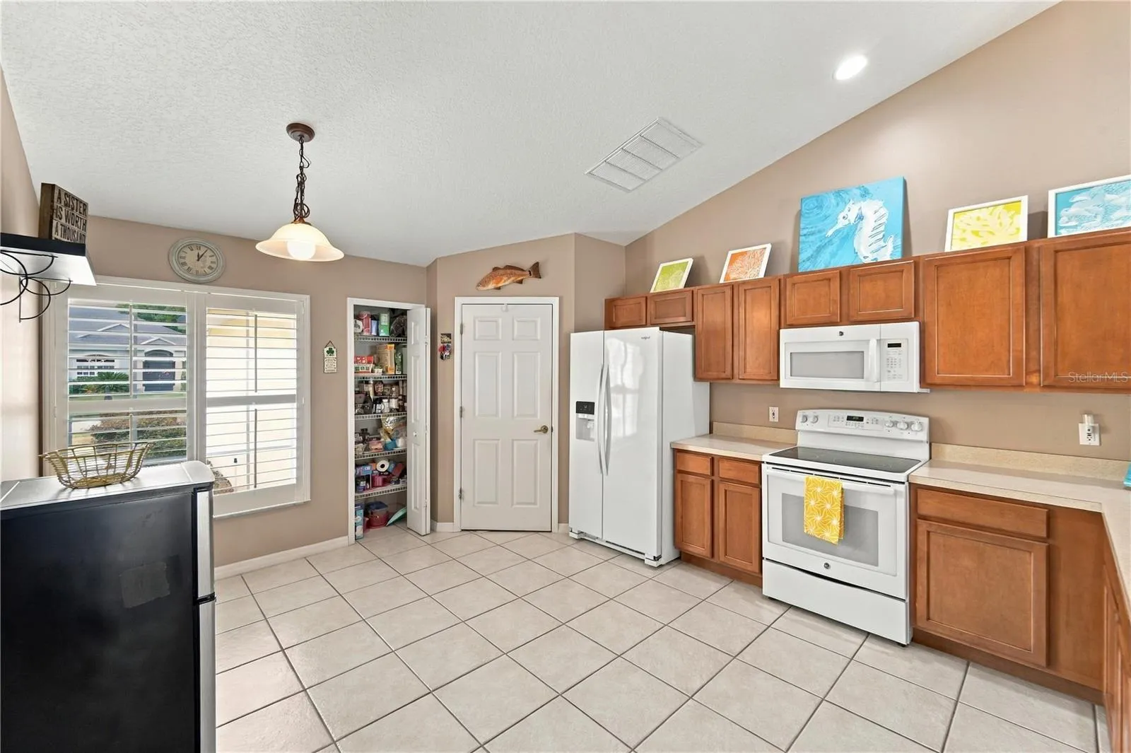 Spacious kitchen with plenty of cabinets, pantry and room for a breakfast nook table.  Closed door is to separate laundry room.