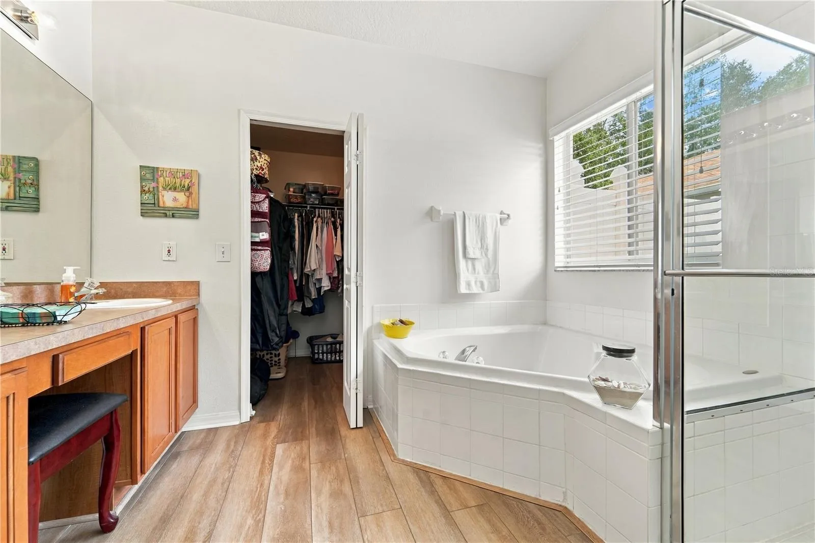 Primary bathroom with seating area and walk-in closet