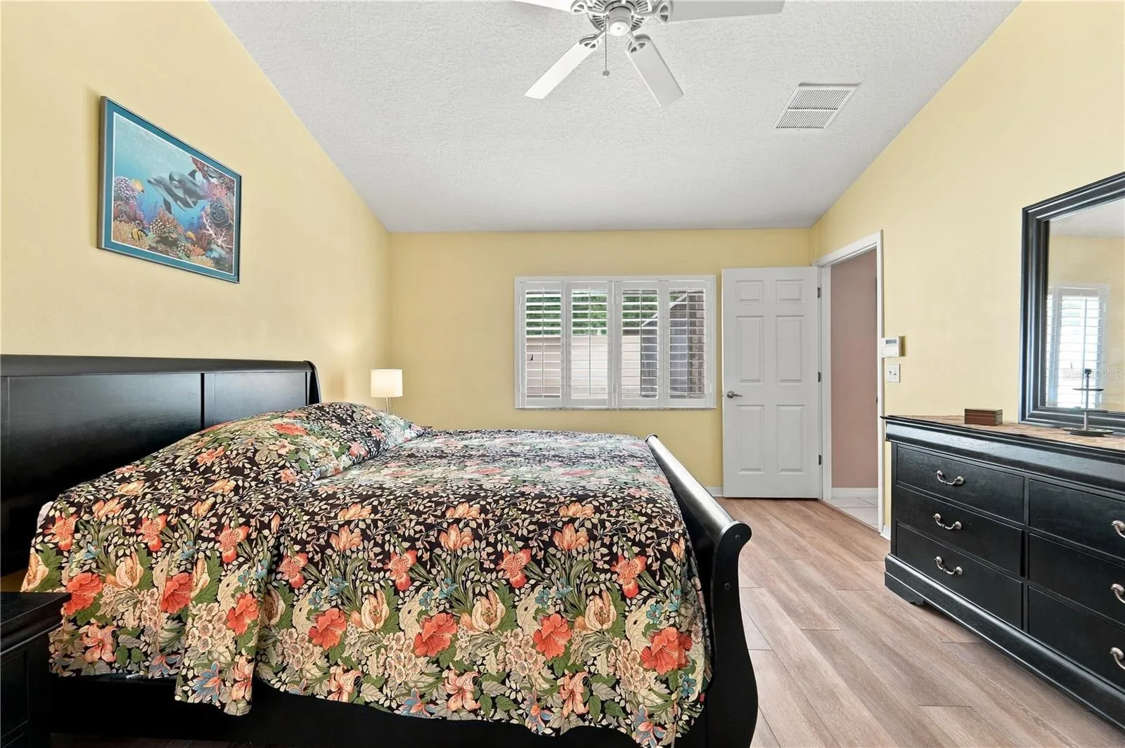 Primary bedroom with luxury vinyl plank flooring.