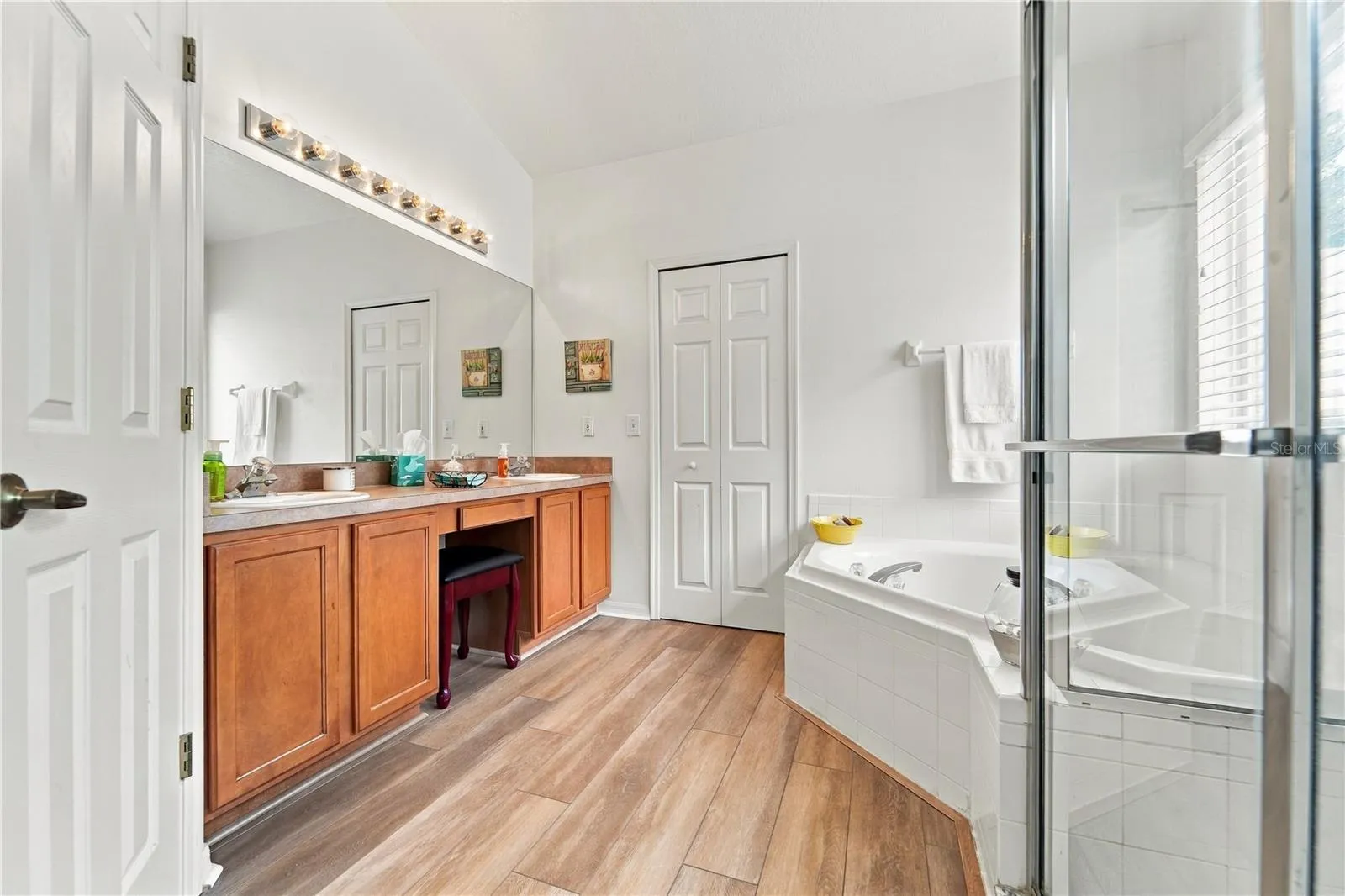 Primary bathroom with double sinks, tub and shower.