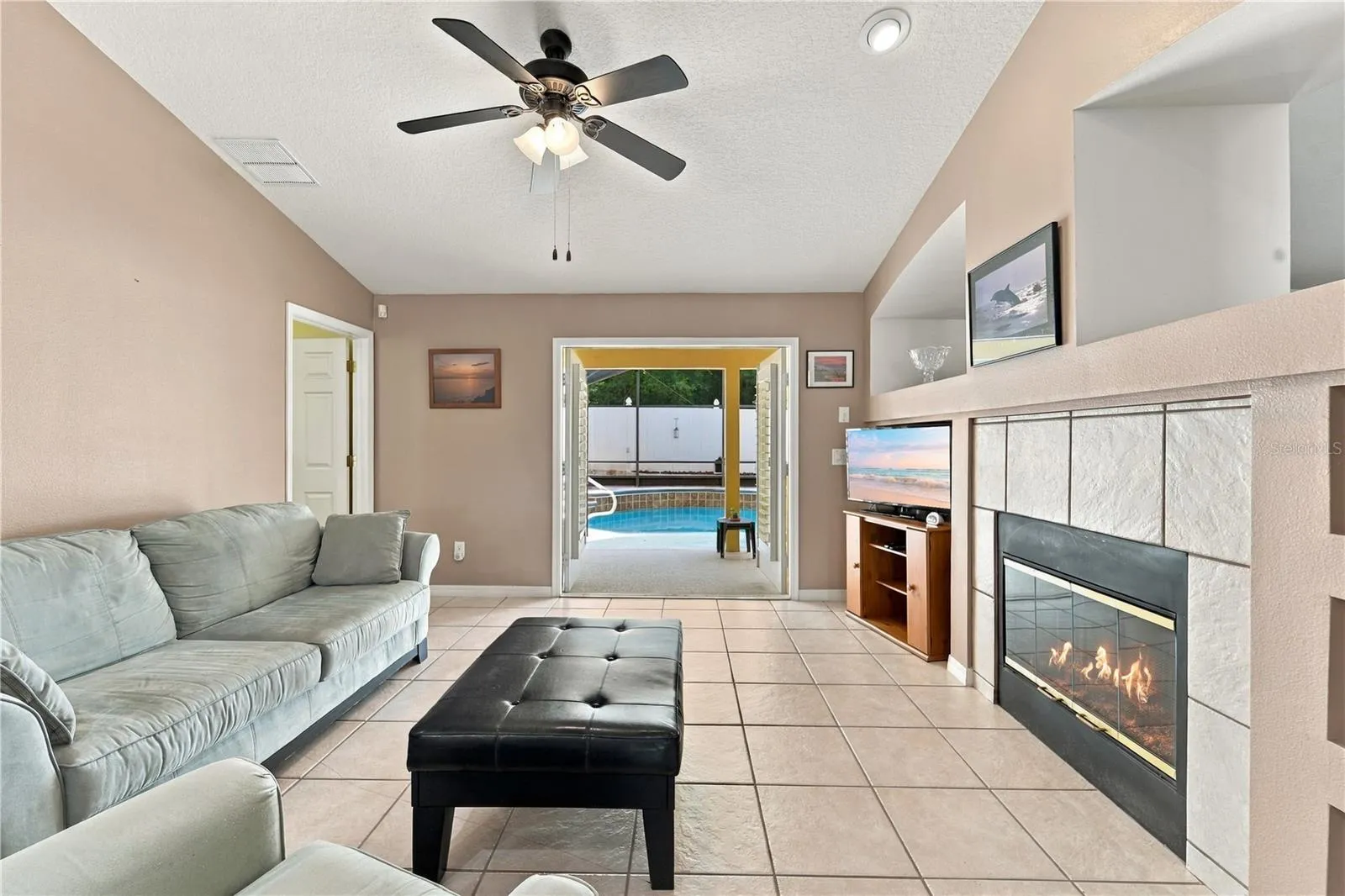 Separate family room with built in shelves and wood-burning fireplace