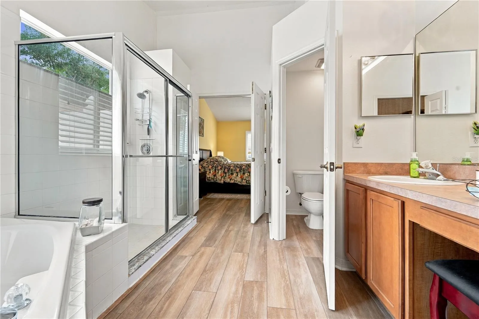Another view of primary bathroom looking from walk-in closet