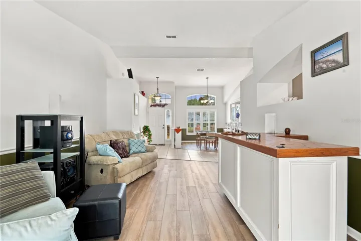 Looking from pool area towards front door and showing living room and dining room.