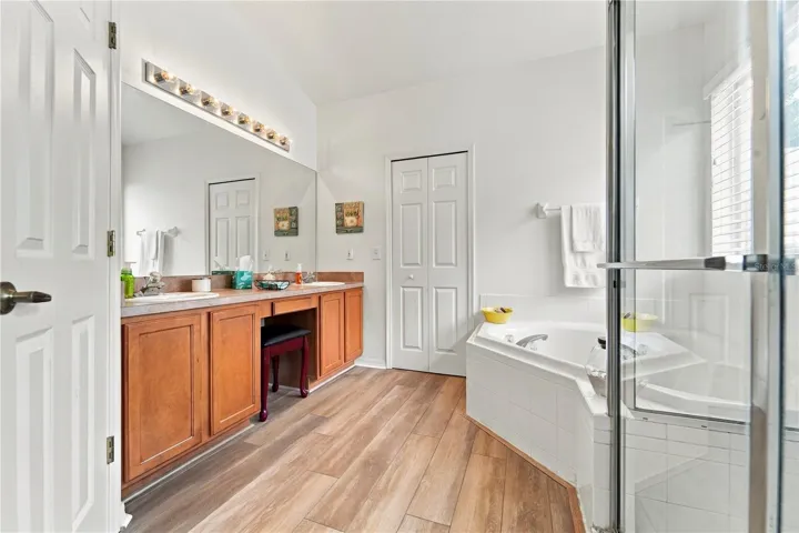 Primary bathroom with double sinks, tub and shower.