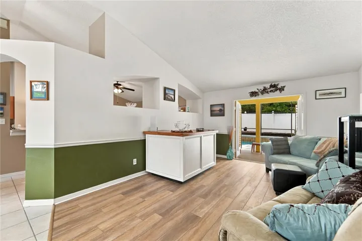 Living room with French doors out to the pool and screened porch