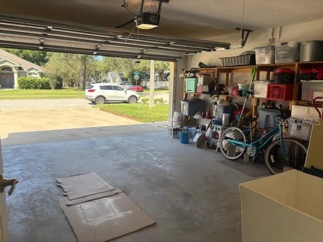 2-car garage with built in shelving and wash tub.