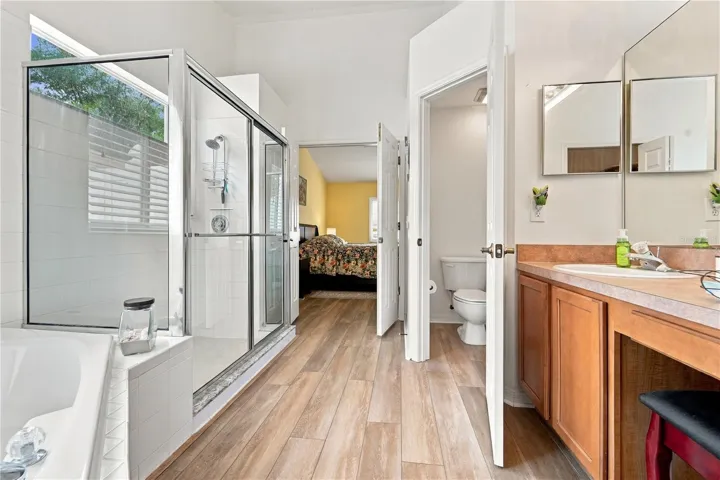 Another view of primary bathroom looking from walk-in closet