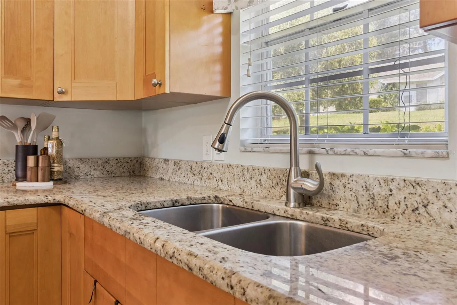 Culinary hosts appreciate the 42" cabinets to the ceiling, pull-out shelves, lazy Susan, and window that brings in natural sunlight over the  deep, double kitchen sink.