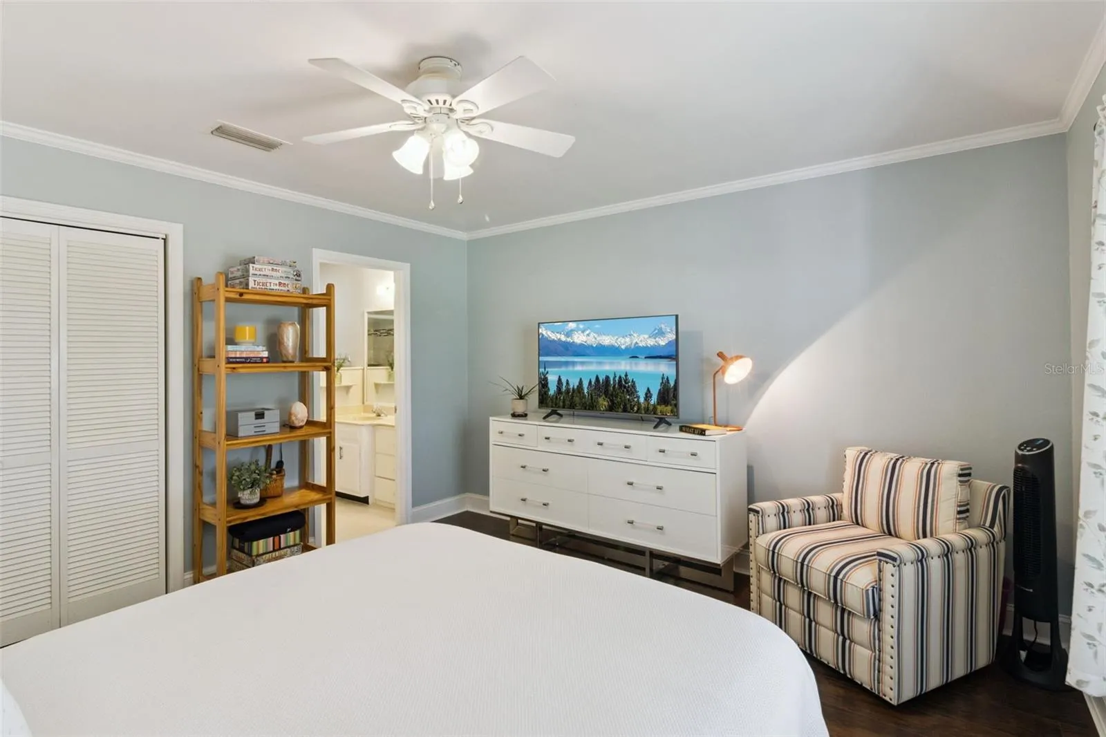 Primary bedroom is a comfortable haven with crown molding, no carpet, and full en suite bathroom.